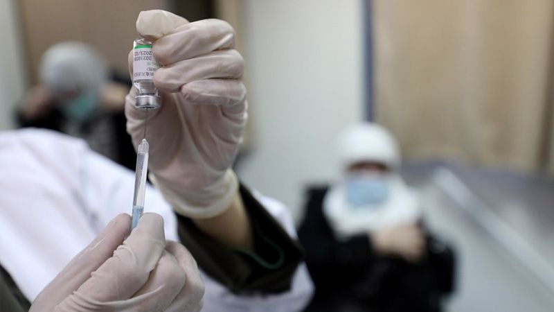 A health worker prepares a dose of Sinopharm COVID-19 vaccine